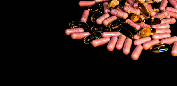 istock Vitamin D and Fish Oil Capsules (Omega 3) on dark background. Selective focus. 1226196193