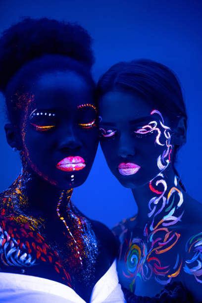 istock two girls with fluorescent make-up isolated 1226196247