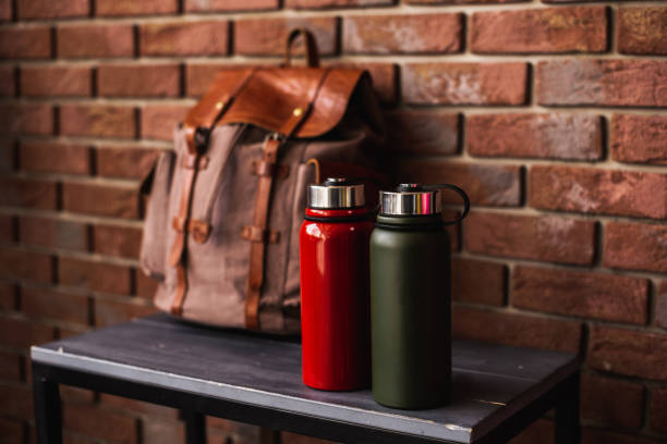Hipster thermoses and brown backpack. Travel bag