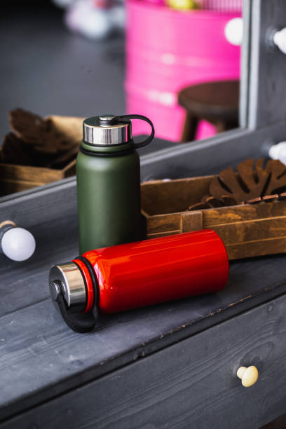 istock Two Green Thermos or Thermo flask on a wooden background 1226201490