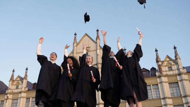 Wide shot. Slow motion. Graduation Caps Are Tossed Into The Air By A Happy Group Of Student Friends. Professional shot in 4K resolution. 035. You can use it e.g. in your commercial video, medical, business, presentation, broadcast