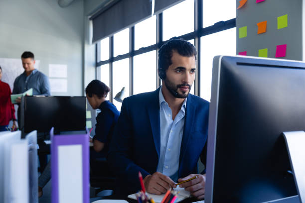 istock Caucasian man working with headset phone in office 1226202902