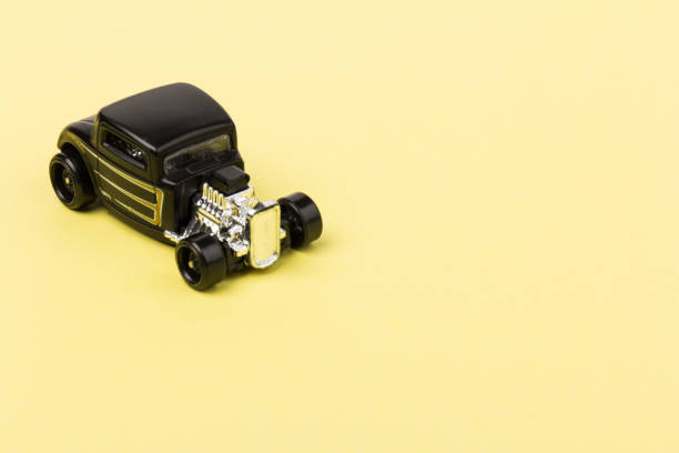 istock Black toy car  isolated on yellow background 1226203370