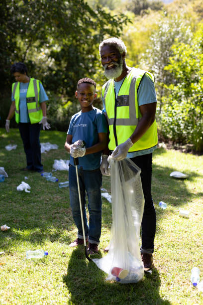 istock Senior African American man and boy collecting garbage 1226204867