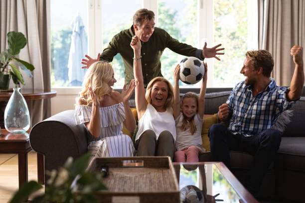 istock Multi-generation Caucasian family sitting on a couch together and watching a game 1226207113