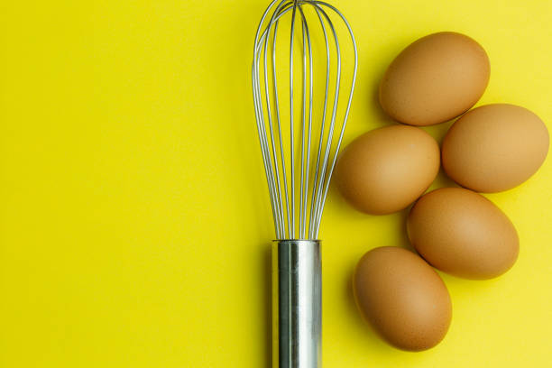 istock Chicken eggs, brown eggs, broken egg in carton box on yellow background. Top view natural eggs in carton box product concept 1226207122
