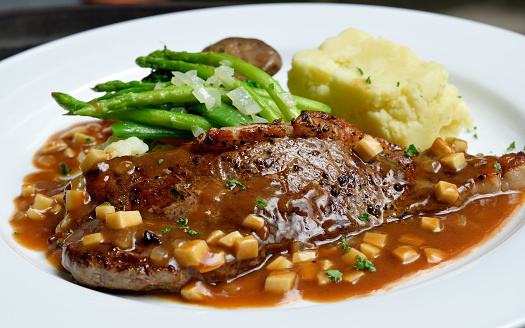 Grilled beef striploin steak with mash potato and vegetable