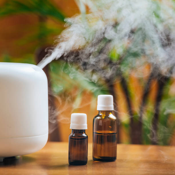 istock Natural Essential Oil Bottles and Aroma Therapy Diffuser on a Wooden Table 1226208398