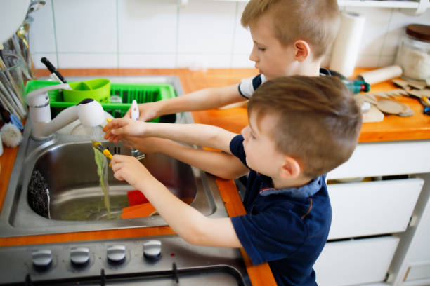 istock Boys Washing brushes in the sink 1226208740