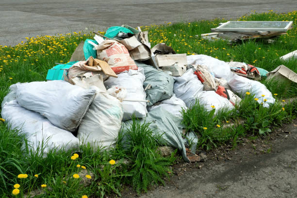 Pile of construction waste in bags and old wooden window frames on green grass. Ufa, Russia - 15 May, 2020. Pile of construction waste in bags and old wooden window frames on green grass. Ufa, Russia - 15 May, 2020 utilize stock pictures, royalty-free photos & images