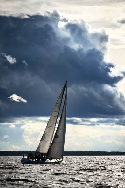 istock Sailing yacht regatta. Modern sailboat racing through the waves. Dramatic sky before the thunderstorm. Terrific cloudscape. North Germany, Kiel 1226217700