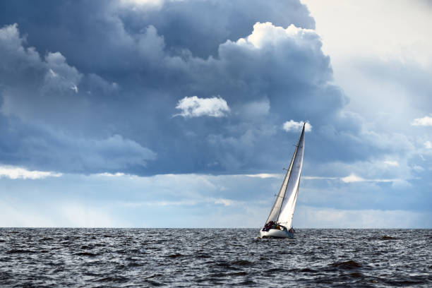 istock Sailing yacht regatta. Modern sailboat racing through the waves. Dramatic sky before the thunderstorm. Terrific cloudscape. North Germany, Kiel 1226217801