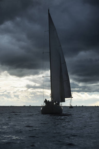 istock Sailing yacht regatta. Modern sailboat racing through the waves. Dramatic sky before the thunderstorm. Terrific cloudscape. North Germany, Kiel 1226217806