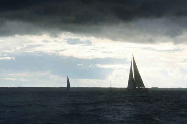 istock Sailing yacht regatta. Modern sailboat racing through the waves. Dramatic sky before the thunderstorm. Terrific cloudscape. North Germany, Kiel 1226217832
