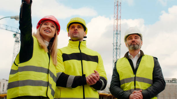 istock Female building engineer supervising construction site. Pointing cranes 1226217858