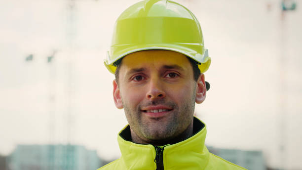 istock Portrait of smiling building constructor in his workplace. Cranes in background 1226217951