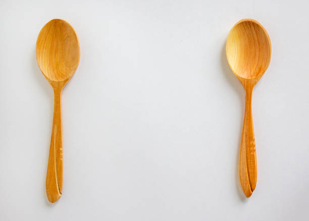 istock Two beautiful wooden spoons isolated on white background. 1226219181