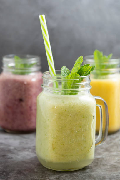 assortment of fruit smothie in glass jars, summer refreshing drinks. - drink on top of ice food imagens e fotografias de stock