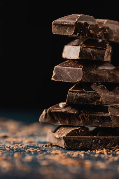 istock Stack of dark chocolate pieces on dark background. Close-up. Copy space. 1226223268