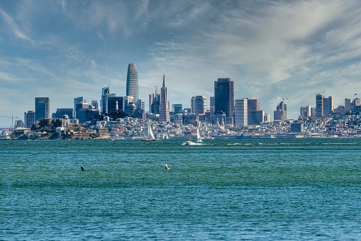View of the San Francisco skyline across the bay . Looking at the majestic skyline from Tiburon. Sailboats and motorboats in the Bay on a sunny day with the San francisco skyline as a backdrop.