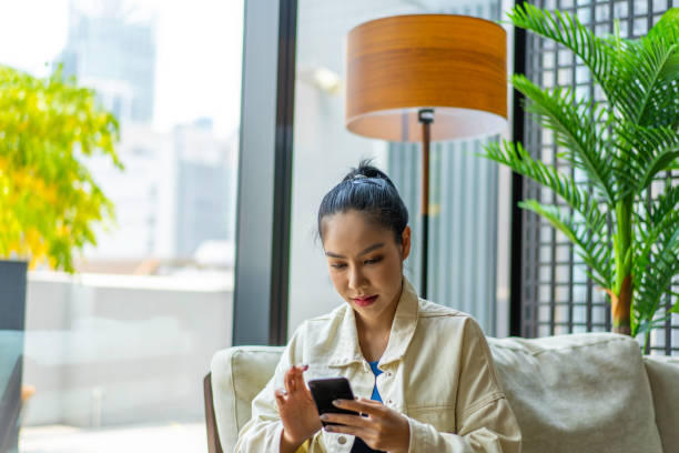 istock Young Asian Millennial text messaging a friend 1226229694