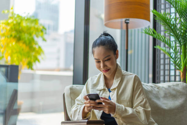 istock Young Asian Millennial text messaging a friend 1226231387