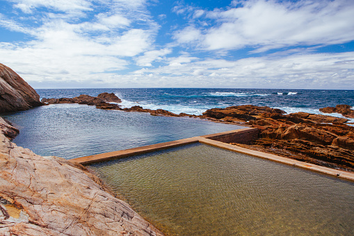 The iconic and famous Blue Pool on a cool autumn afternoon in Bermagui, New South Wales, Australia