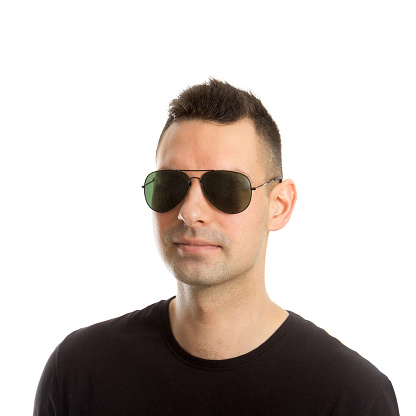 Headshot of a young man wearing aviator sunglasses, isolated on white