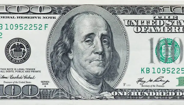 Photo of Concept showing devaluation of american dollars by Quantitative easing programme - crying Benjamin Franklin