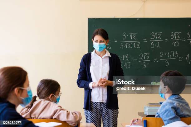 Female Teacher Teaching Mathematics At School During Covid19 Stock Photo - Download Image Now