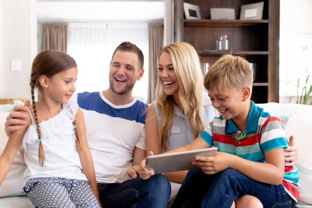 istock Caucasian family with two children using a tablet computer at home 1226233286
