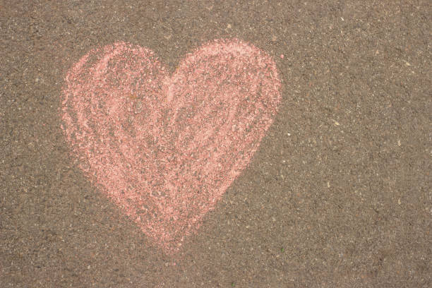 istock heart is drawn in red chalk on the asphalt 1226234590