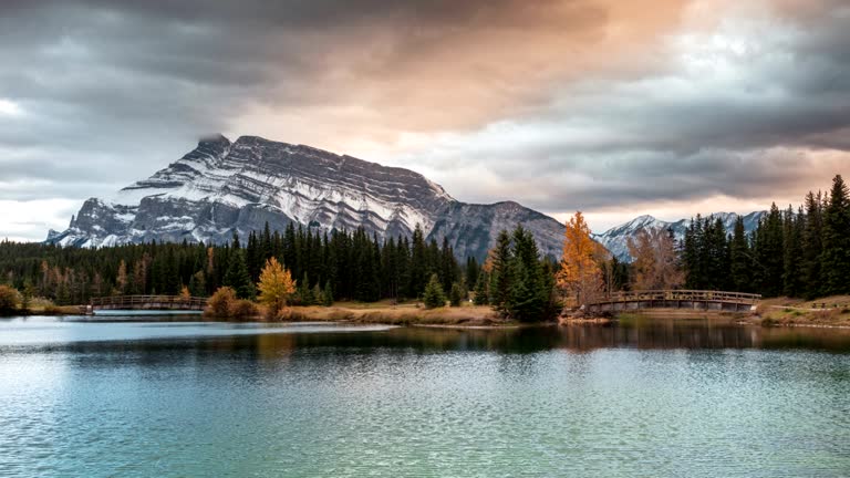 Mount Rundle with wooden bridge in autumn park at Cascade Ponds, Banff national park