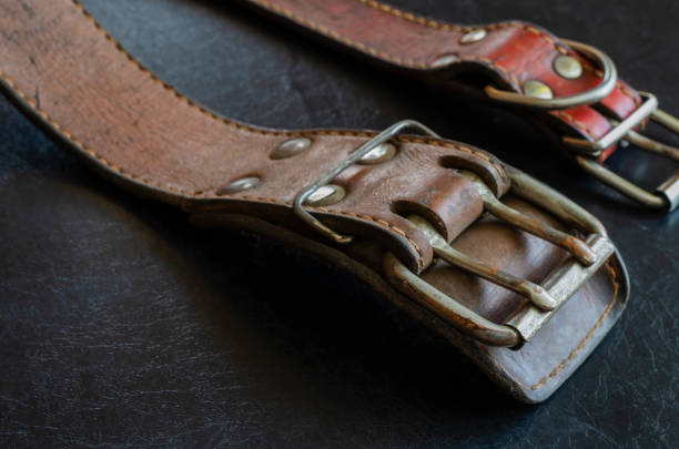 istock Fragment of two old genuine leather collars on a dark table. 1226237307