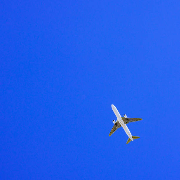 istock air plane in the background of blue sky 1226237423