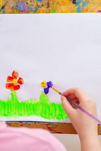 istock Child is drawing flowers 1226237591