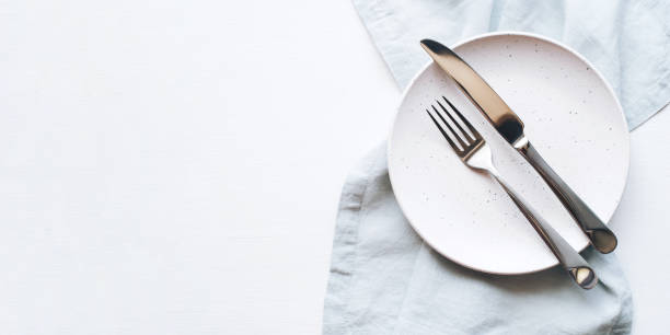 istock An empty plate and Cutlery on a white table. 1226238508