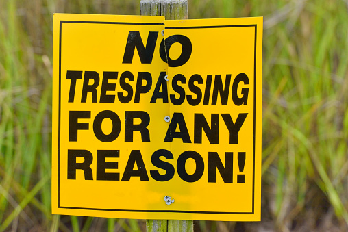 A very emphatic No Trespassing sign leaves no doubt that you are to stay off of this property and you cannot rationalize your way out of it