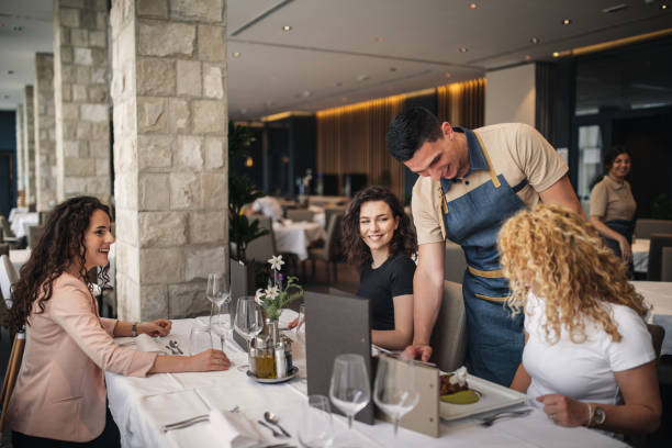 istock Waiter Serving  Drinks And Food In Restaurant 1226241704