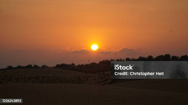 Sunset Over The Red Sand Dunes Desert Near Mũi Né Beach Resort In Vietnam Stock Photo - Download Image Now