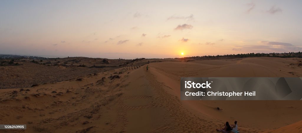 Sunset over the Red Sand Dunes desert near Mũi Né Beach Resort in Vietnam. Adventure Stock Photo