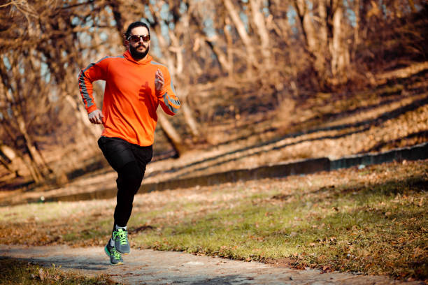 istock Front view of a handsome young man jogging 1226245272