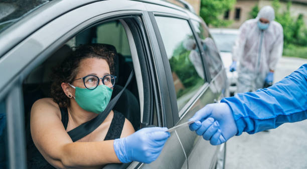 istock Man with protective suit checking woman at border controlling during COVID-19 1226245297