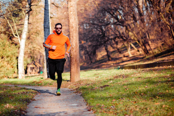 istock Front view of a handsome young man jogging 1226245316