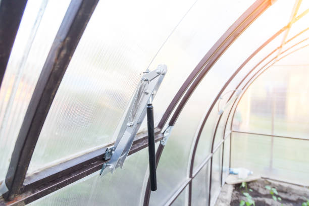 istock Automatic system with an aluminum-zinc coating for opening a window in a greenhouse with a thermo regulator is used to ventilate the room without human intervention - higher temperature, wider opens. 1226245438