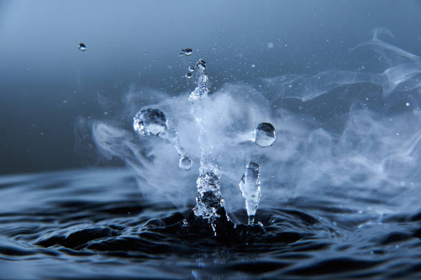 istock Boiling water splash with steam on dark blue background closeup 1226246060