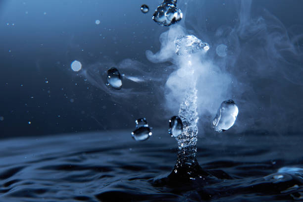 istock Boiling water splash with steam on dark blue background closeup 1226246062