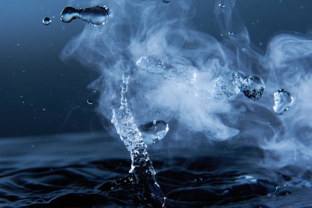 istock Boiling water splash with steam on dark blue background closeup 1226246067