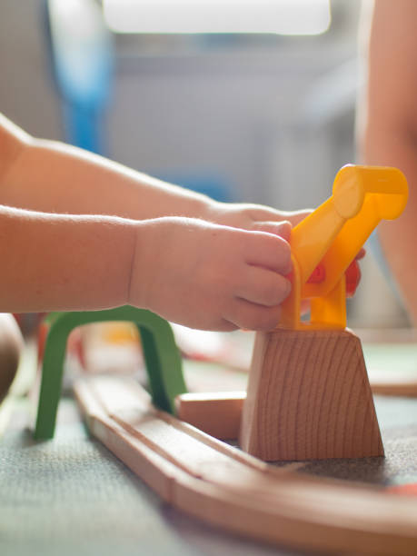 istock toddler playing with toy train. games at home during self-isolation 1226246813