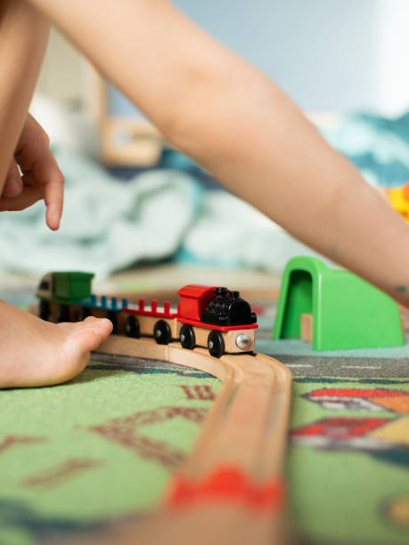 istock toddler playing with toy train. games at home during self-isolation 1226247260